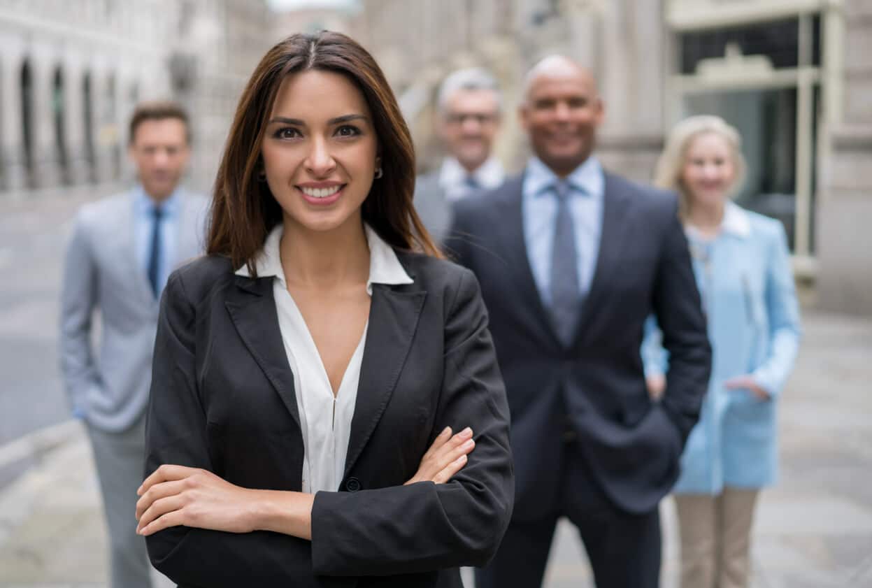 A chief legal officer confidently stands with the agile legal team she helped build.